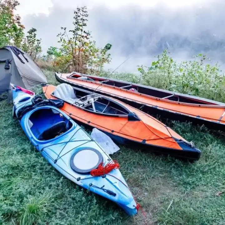Kayaks ready beside camp on a foggy morning.