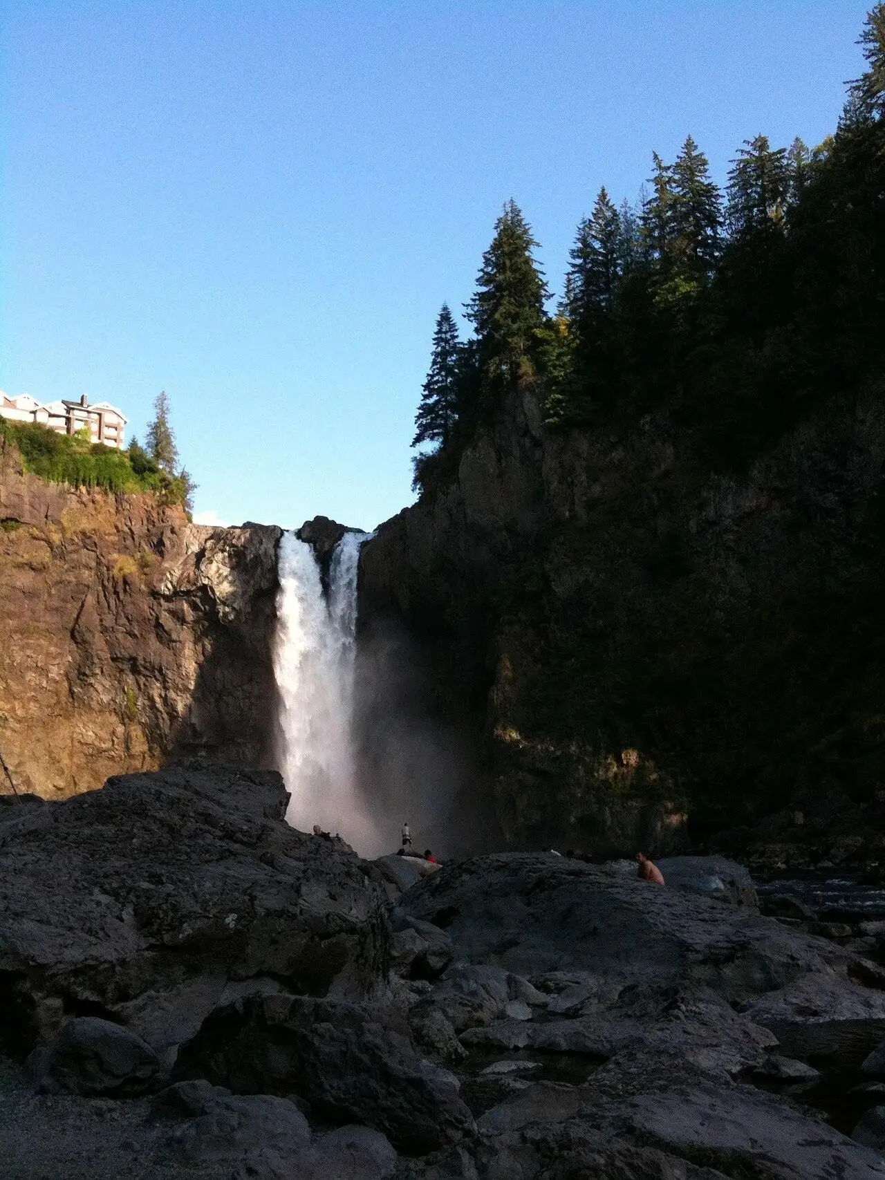 Snoqualmie Falls seen from the public viewpoint, with mist above the river.